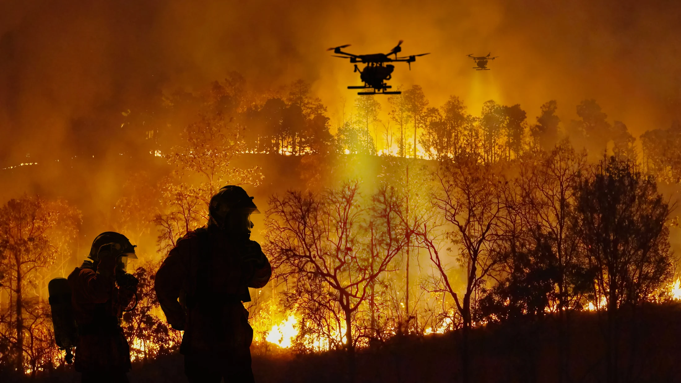 Illustrative scene of response personnel and a drone near a wildfire